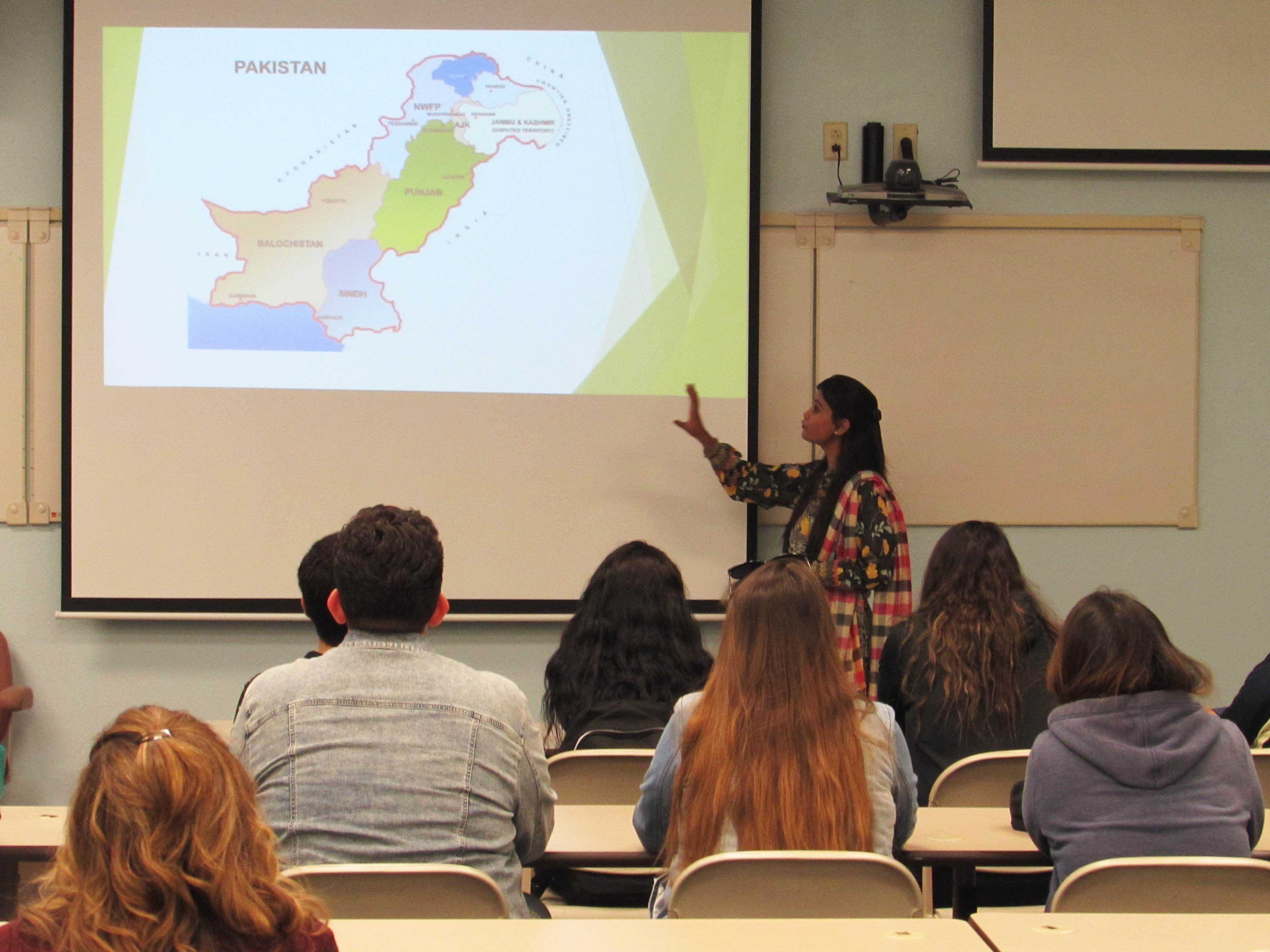 A student is presenting on Pakistan to a group of students 
