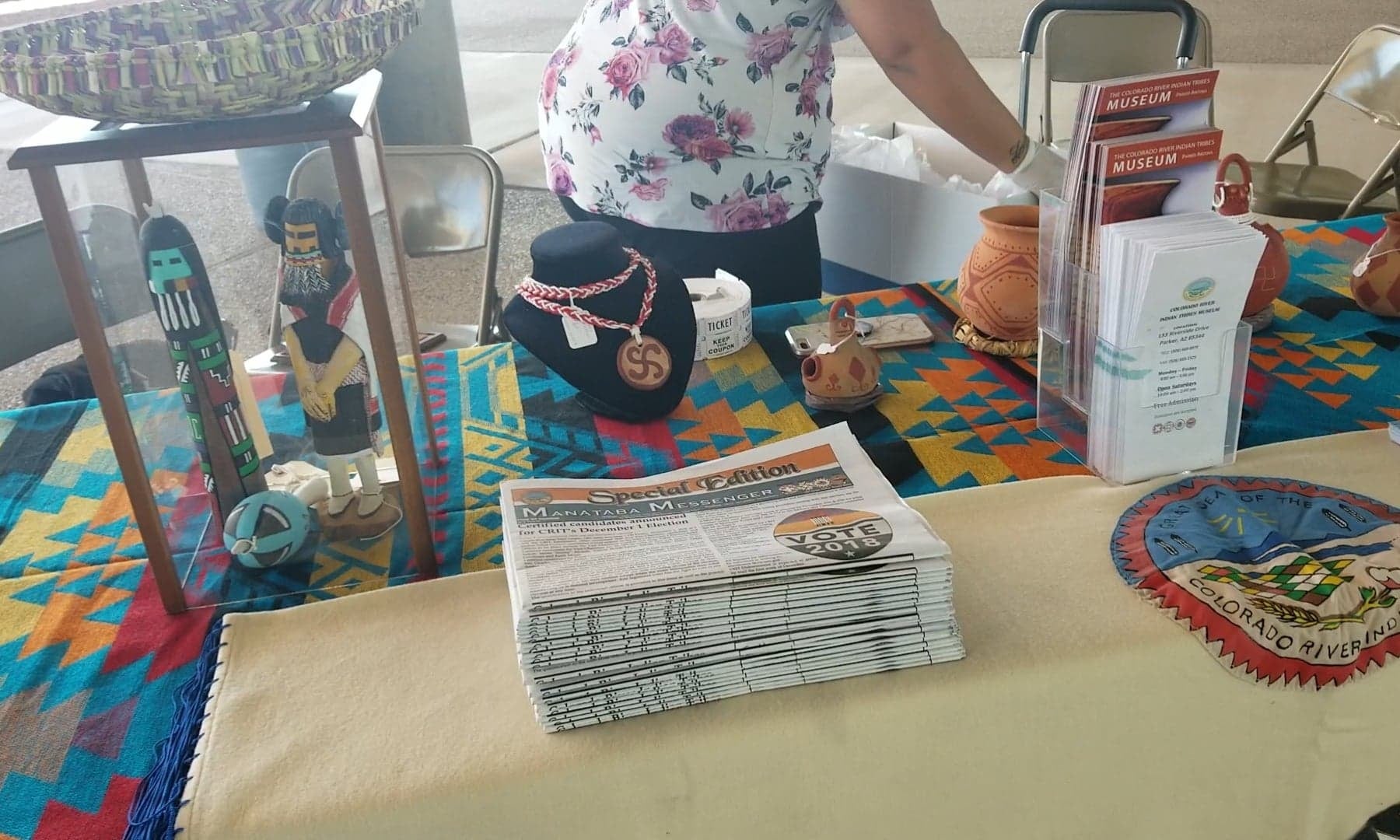 Native American jewelry, art, and newspapers on display