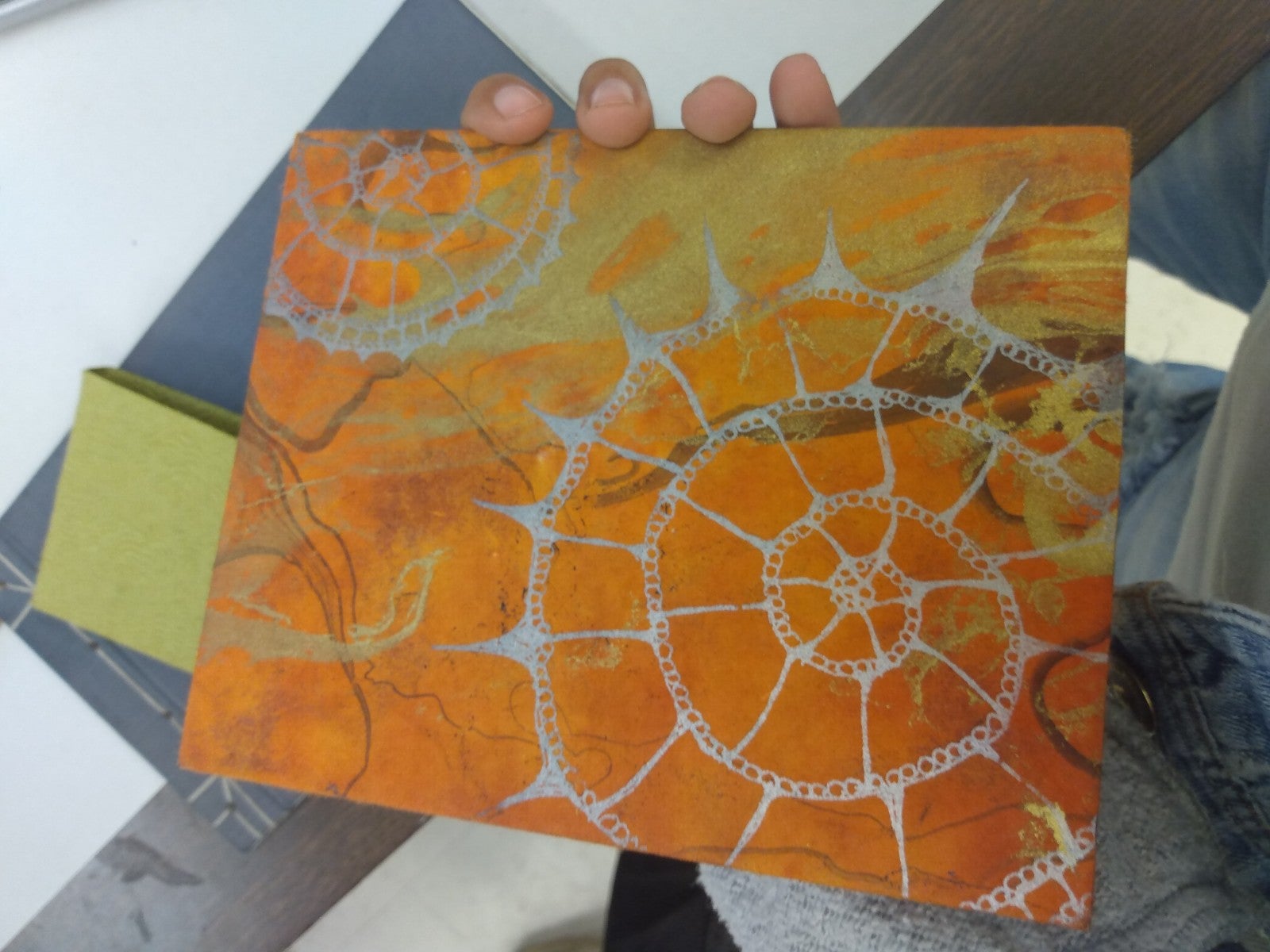 Orange-colored art with a shell pattern is pictured