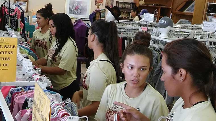 Softball players volunteered at Amberly's Place Thlrift Shoppe.