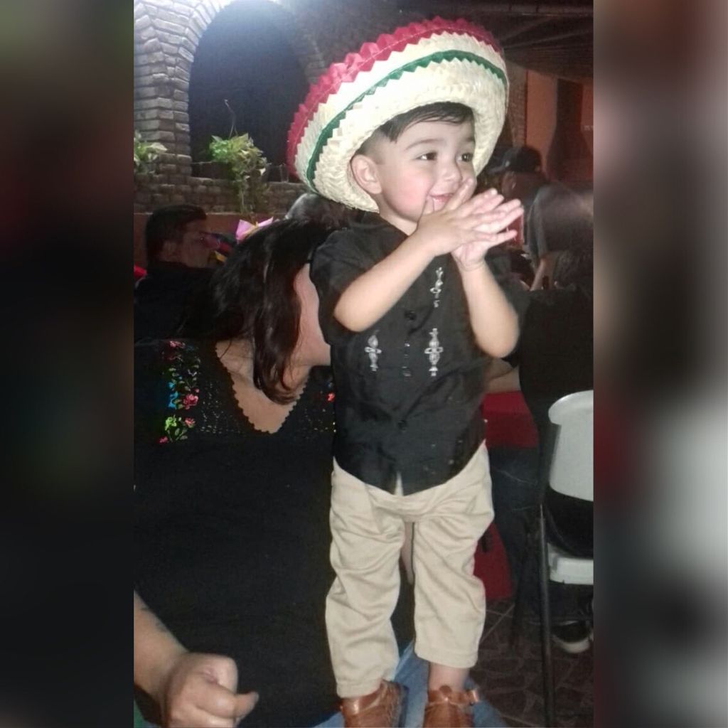 A child participates in the festivities on Mexico's Independence Day. image of a boy in a Mexican-themed hat