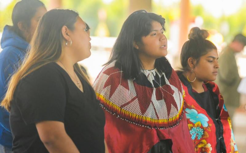 Courtesy of AWC Photo Services Three girls looking at something out of frame
