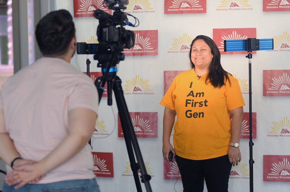 Girl in front of a camera while a man is behind the camera