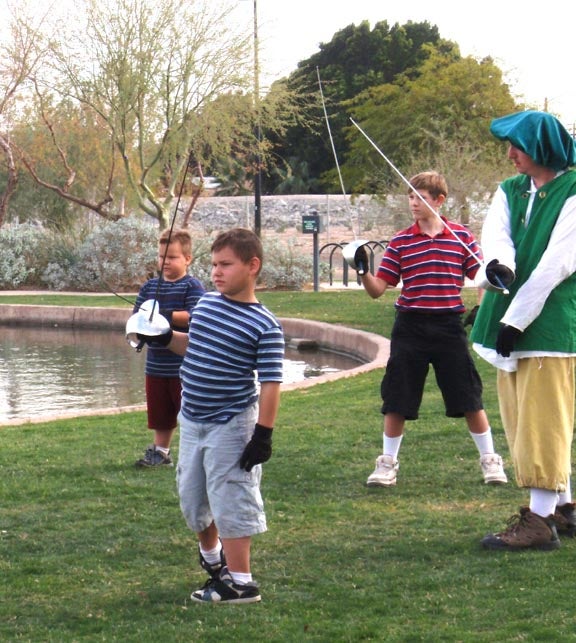 Kids learning to fence by AWC Theatre group at Ren Faire. Photo by Rudy Gonzalez.