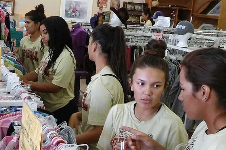 Softball players volunteered at Amberly's Place Thlrift Shoppe.