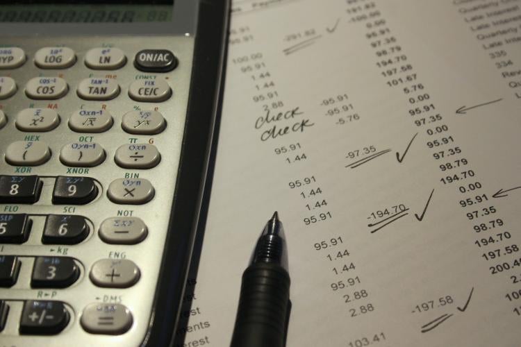 Photo illustration from pixabay.com A calculator and pen sit atop a paper used for finance checking