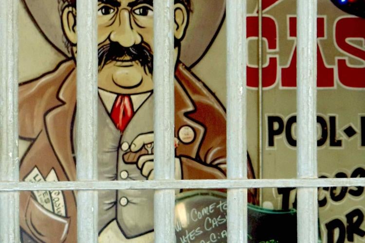 The front entrance of Lutes Casino gives a preview of the campy artwork inside. Photo by Pam Black A classic art of a man with a big black mustache and cowboy hat is shown behind bars. The art is typically associated with Lutes Casino