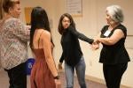 Instructor teaching group of women a self-defense tactic.