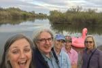 A group of people pose in front of the river