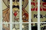 A classic art of a man with a big black mustache and cowboy hat is shown behind bars. The art is typically associated with Lutes Casino