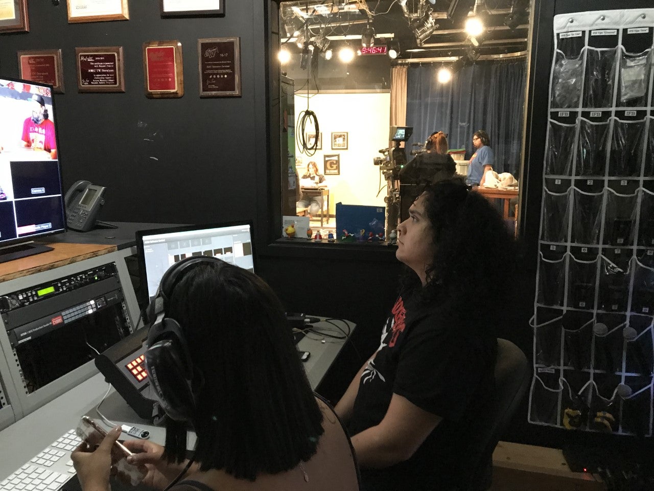 Students are seated by computers, working on the production of the show